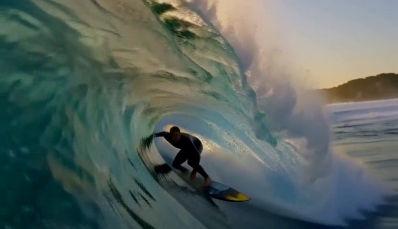 A surfer riding inside a turquoise wave barrel at sunset, made with MiniMax H3 Max