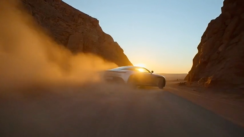 A silver sports car drifting out of a dust cloud in a desert canyon at sunset, made with Seedance 2.5
